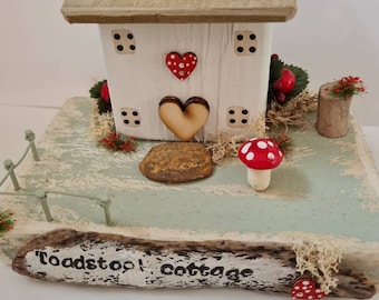 Toadstool cottage. Little white cottage with toadstool, shrubs and flowers and hand stamped plaque.mothers day gift.fairy land.