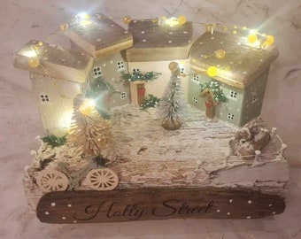 Holly street, driftwood Christmas village in sage green and white.