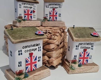 Coronation cottage.white cottage with Union Jack door, hand painted Union Jack and flowers. Pretty collectors peice to keep forever.