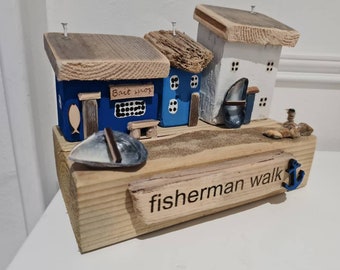 Fisherman walk. Row off cottages and bait shop,fishing boats,shingle,rocks and lasered signs. Driftwood and reclaimed wood.fathers day gift