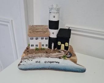 Old dungerness.lighthouse and old white house and black shack cottage.shingle beach and rocks, and little boat and hand stamped plaque.gift