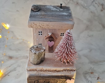 Comfort and joy.pink and cream Christmas cottage with Christmas tree