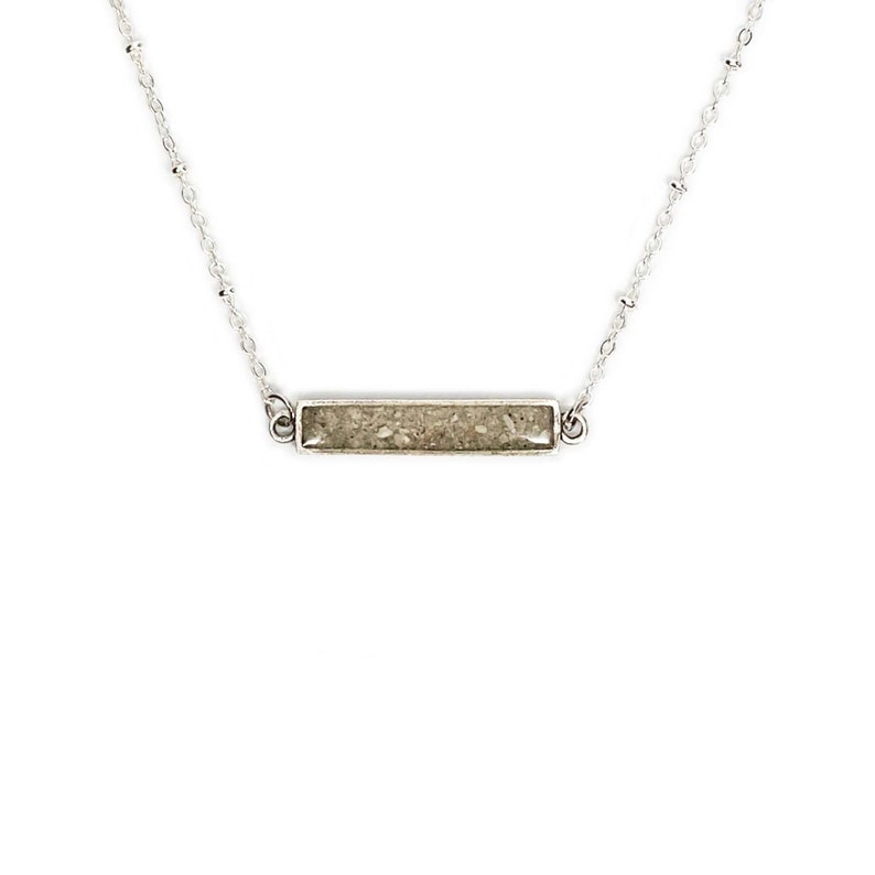 a sand bar necklace made with real beach sand inside.