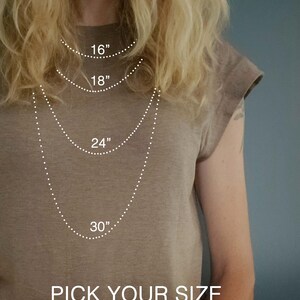 May include: Image showing a person wearing a brown t-shirt with a necklace size guide. The guide displays necklace lengths of 16", 18", 24", and 30". Text at the bottom reads "PICK YOUR SIZE" and "Boheme WILD".