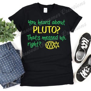 May include: Black t-shirt with green and yellow text that reads "You heard about Pluto? That's messed up, right?" and a pineapple graphic.