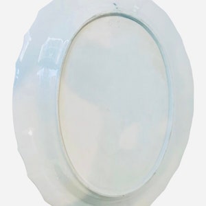 May include: White ceramic plate with a scalloped edge. The plate is plain white with no design.