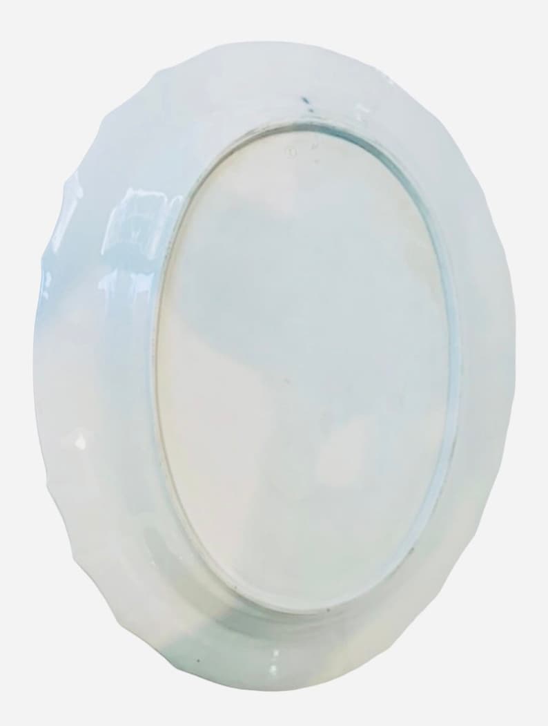 May include: White ceramic plate with a scalloped edge. The plate is plain white with no design.