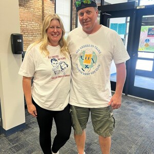 May include: Two people wearing white t-shirts with the text "All Cheers! No Tears! College Drop Off Club" and a cartoon beer mug. The man is wearing a black baseball cap and green cargo shorts. The woman is wearing black leggings.