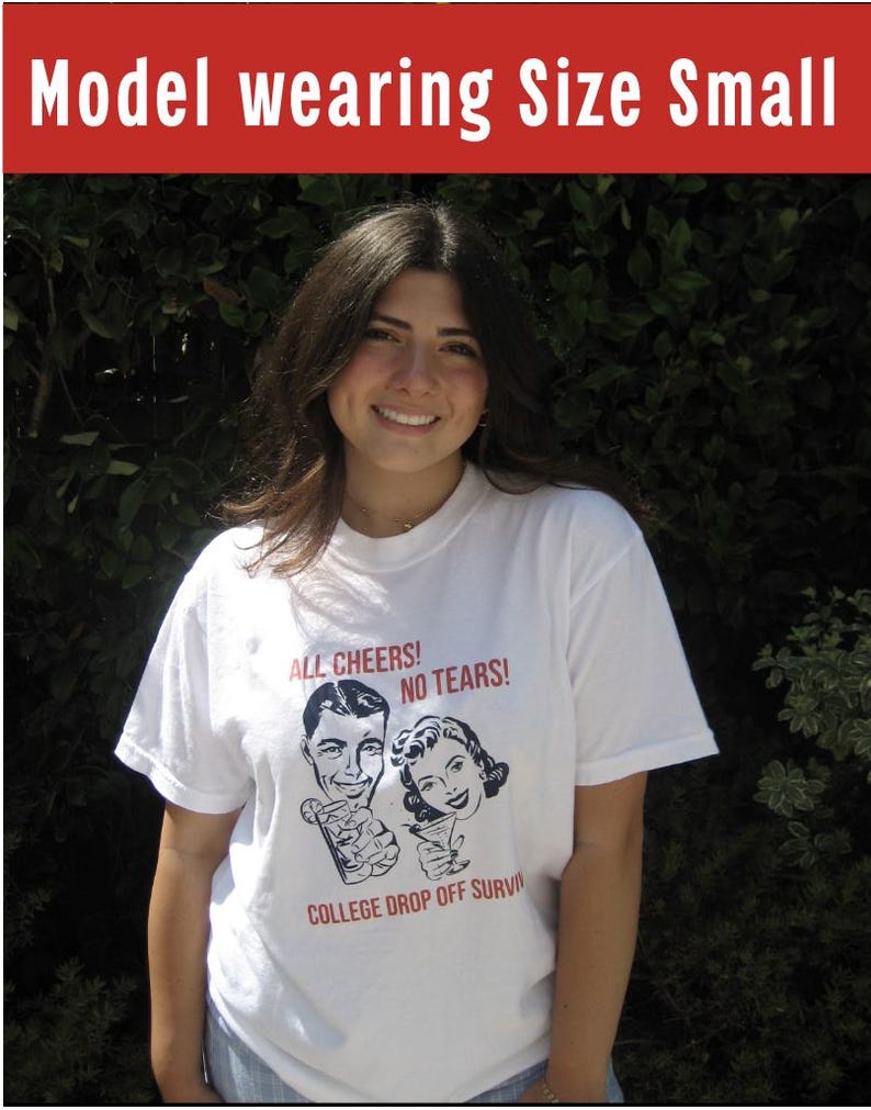 May include: A white t-shirt with a black and white illustration of a man and woman holding drinks. The text on the shirt reads "All Cheers! No Tears! College Drop Off Survived".