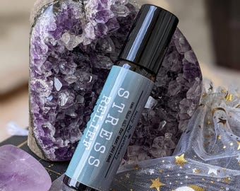 May include: A blue roller bottle with a white label that reads "STRESS RELIEF" and "Peace for you, all the time, in the palm of your hand.  Knots melt away.  Aromatherapy.  All Natural."