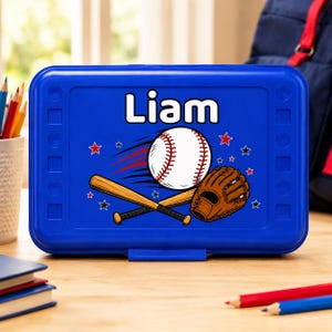 May include: A rectangular blue lunch box featuring the name Liam in white text. The design includes a white baseball with red stitching, a wooden baseball bat, a brown leather baseball glove, and small red and black star graphics.