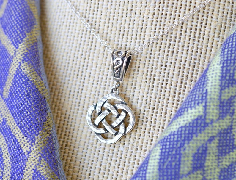 May include: A silver Celtic knot pendant necklace with a delicate chain. The knot is a traditional symbol of love, friendship, and eternity.