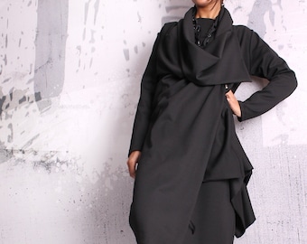 May include: A black long-sleeved dress with a draped cowl neck and a long skirt. The dress is made of a soft, flowing fabric and has a relaxed fit.