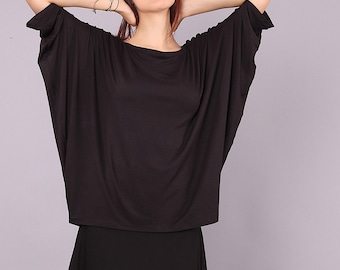 May include: A black, loose-fitting, short-sleeved top with a boat neck.
