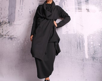 May include: A black long-sleeved dress with a draped cowl neck and a long, flowing skirt. The dress is made of a soft, comfortable fabric and has a relaxed fit.