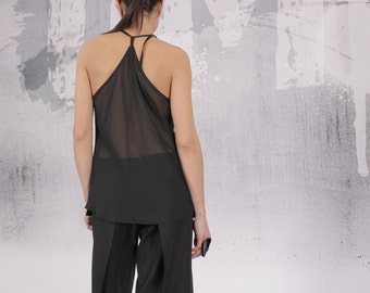 May include: A black sheer sleeveless top with a scoop neck and a loose fit. The top is made of a lightweight fabric and has a flowing silhouette.