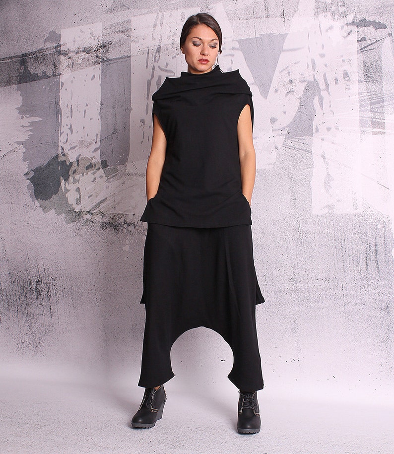May include: A black, high-waisted, wide-leg pants with a loose, flowing fit. The pants have a unique, draped design and a relaxed, comfortable look.