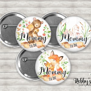 May include: Three 2.25 inch button pins with watercolor illustrations of a bear, swan, and fox with the text "Mommy to be" on each pin.
