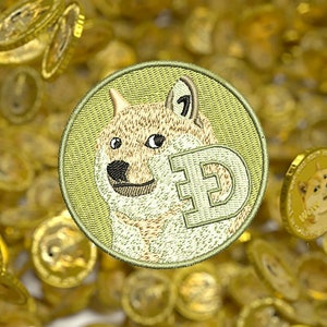May include: A gold Doge coin with a Shiba Inu dog face and the letter "D" in the center, surrounded by a sea of gold coins.