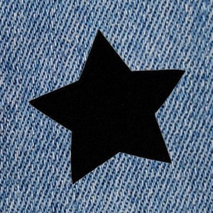 Könnte beinhalten: Eine schwarze Sternform auf einem blauen Jeansstoff.