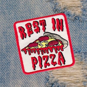 May include: A white patch with red stitching features a red and yellow pizza slice with the text "Rest in Pizza" in red.