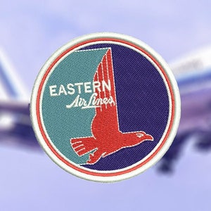 May include: A round, blue and green patch with a white border. The patch features a red bird in flight with the text "Eastern Airlines" in white.