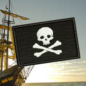 May include: A black and white pirate flag with a skull and crossbones design. The flag is attached to a large sailing ship in the background.