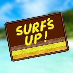 May include: A brown and yellow embroidered patch with the text "SURF'S UP!" in yellow lettering.