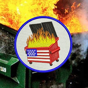 May include: A blue and white embroidered patch with a red, white, and blue dumpster on fire. The dumpster has an American flag design.