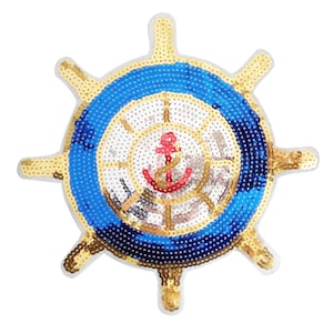 May include: A gold and blue sequined iron wheel with a red anchor in the center. The wheel has eight spokes and is surrounded by a blue circle with a gold border.