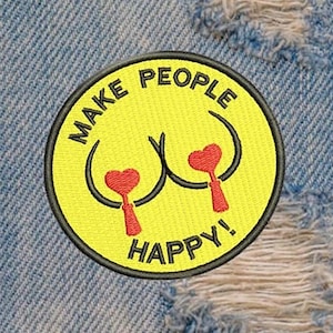 May include: Embroidered patch with a yellow background and the words "MAKE PEOPLE HAPPY!" in black. The design includes a smiley face with two breasts and red heart-shaped nipples. The patch has a black border and is set against a denim background.