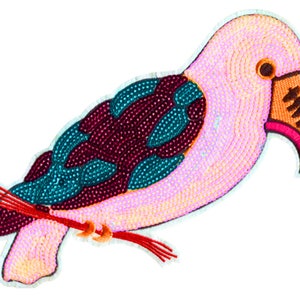 May include: A pink, turquoise, and burgundy sequined bird applique with a bright orange beak. The bird is perched on a red twig.