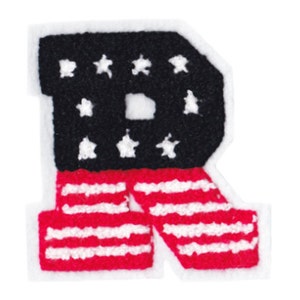 May include: A felt letter "R" patch with a patriotic design. The top section is black with white stars, and the bottom has red and white stripes, similar to the American flag. The patch is edged in white.