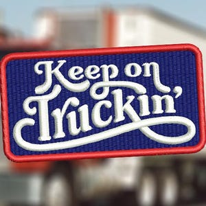 Puede incluir: Parche bordado rojo, blanco y azul con el texto "Keep on Truckin'" en una fuente blanca cursiva.