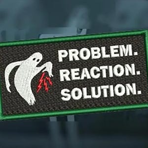 May include: A black and green embroidered patch featuring a white ghost holding a lightning bolt. The text on the patch reads "PROBLEM. REACTION. SOLUTION."