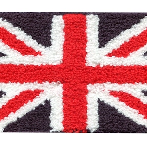 May include: A close-up of a Union Jack flag rug. The rug is made of a soft, plush material and features the iconic red, white, and blue colors of the British flag.