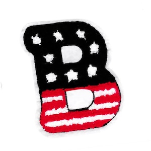 May include: A red, white, and blue felt letter B with a star pattern on the top half and a striped pattern on the bottom half.