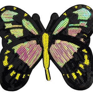 May include: A black and yellow butterfly with iridescent wings. The butterfly is made of sequins and is perfect for adding a touch of sparkle to any project.