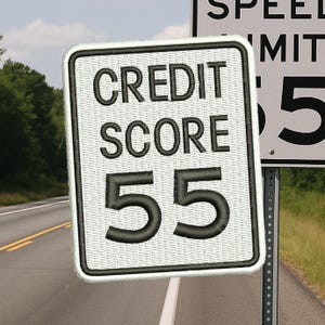 May include: Embroidered patch resembling a road sign, featuring the words "CREDIT SCORE 55" in black thread on a white background. The patch is rectangular with rounded corners and a black border. A speed limit sign is visible in the background.