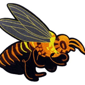 May include: An embroidered iron-on patch of a yellow and black bee with wings. The bee is in flight and has a detailed design.
