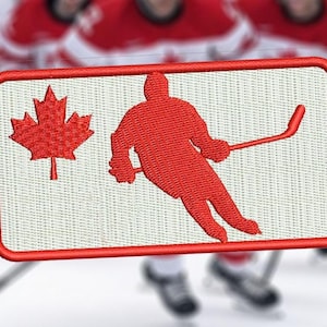 May include: Embroidered patch featuring a red maple leaf and a hockey player silhouette. The patch has a white background with a red border. The image is set against a blurred background of hockey players in red and white uniforms.