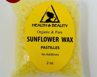 May include: A clear plastic bag filled with yellow sunflower wax pastilles. A yellow oval label reads "HEALTH & BEAUTY Organic & Pure SUNFLOWER WAX PASTILLES No Additives 2 oz". A red and yellow banner in the upper left corner says "SAME DAY FREE SHIPPING".