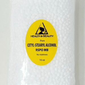 May include: A white plastic bag filled with white beads. The bag has a yellow label with black text that reads "HEALTH & BEAUTY Pure CETYL-STEARYL ALCOHOL RSPO MB No Additives 16 oz".