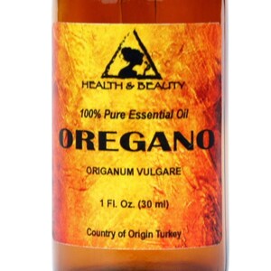 May include: A brown glass bottle with a black dropper top. The label is yellow with a black triangle and the text "HEALTH & BEAUTY 100% Pure Essential Oil  OREGANO  ORIGANUM VULGARE 1 Fl. Oz. (30 ml) Country of Origin Turkey"