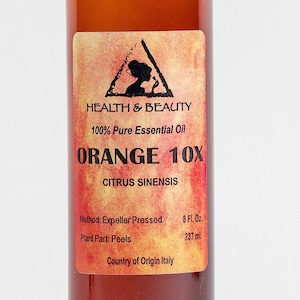 May include: A brown glass bottle with a label that reads "HEALTH & BEAUTY 100% Pure Essential Oil ORANGE 10X CITRUS SINENSIS Method: Expeller Pressed 8 Fl. Oz. Plant Part: Peels 237 ml Country of Origin Italy"