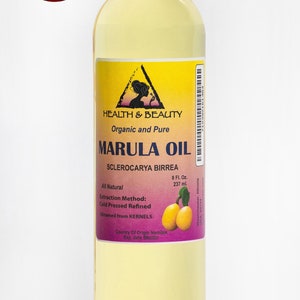 May include: A clear glass bottle of organic and pure marula oil, labeled "Health & Beauty" with the text "Marula Oil Sclerocarya Birrea" and "All Natural Extraction Method: Cold Pressed Refined Obtained from KERNELS Country Of Origin Namibia Exp. date 8 Fl. Oz. 237 ml."