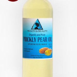 May include: A clear glass bottle with a white cap containing 4 fluid ounces of organic and pure prickly pear oil. The label is blue and white with the text "HEALTH & BEAUTY", "Organic and Pure", "PRICKLY PEAR OIL", "OPUNTIA FICUS INDICA", "4 Fl. Oz", "118 ml", "Extraction Method: Cold Pressed", "Country Of Origin Morocco", and "Exp. date".