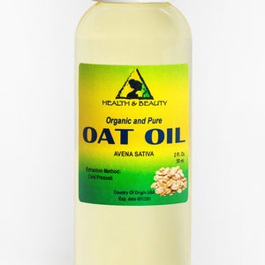 May include: A clear glass bottle with a white cap containing organic and pure oat oil. The label is green and yellow with the text "Health & Beauty", "Organic and Pure", "Oat Oil", "Avena Sativa", "2 Fl. Oz", "59 ml", "Extraction Method: Cold Pressed", "Country of Origin USA", and "Exp. date".