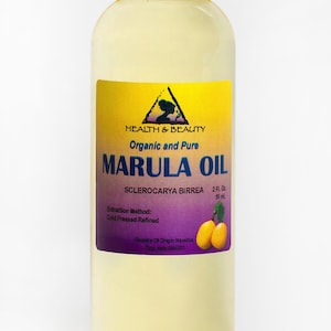 May include: A clear glass bottle with a white cap containing 2 fluid ounces (59 ml) of organic and pure Marula oil. The label is yellow with black text and features a purple triangle with a tree inside. The label also includes the text "Sclerocarya Birrea", "Extraction Method: Cold Pressed Refined", "Country of Origin Namibia", and "Exp. date".