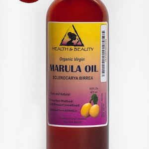 May include: A brown glass bottle of organic virgin marula oil, labeled "Health & Beauty" with a yellow triangle logo. The bottle contains 16 fluid ounces (473 ml) and is labeled "Pure and Natural" with the extraction method as "Cold Pressed Unrefined". The oil is obtained from kernels and the country of origin is Namibia.